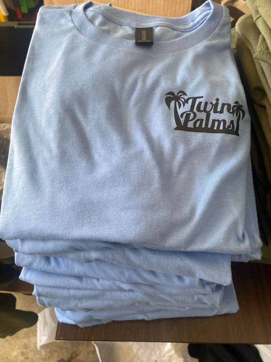 Light blue T-shirt with a small chest graphic, illustrating apparel collection planning