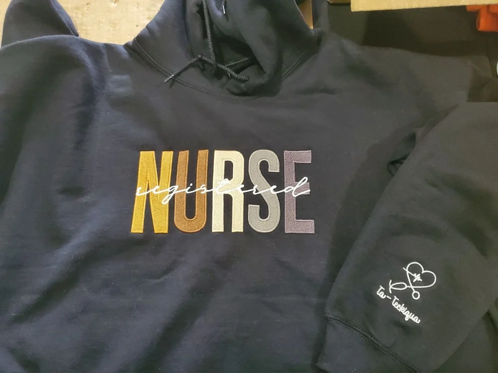 Black Nurse hoodie with gold and white decoration