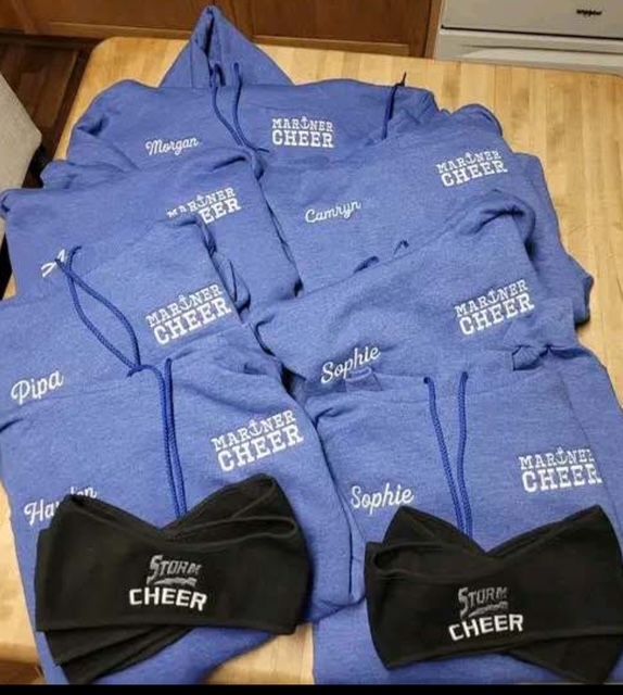 Coordinated purple cheer hoodies and black team garments for spirit merchandise ideas