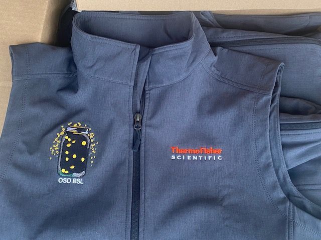 Navy quarter-zip with embroidered Thermo Fisher branding for a coordinated staff apparel program
