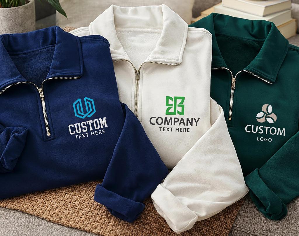 Quarter-zip pullovers in navy, cream and green with custom embroidered logos