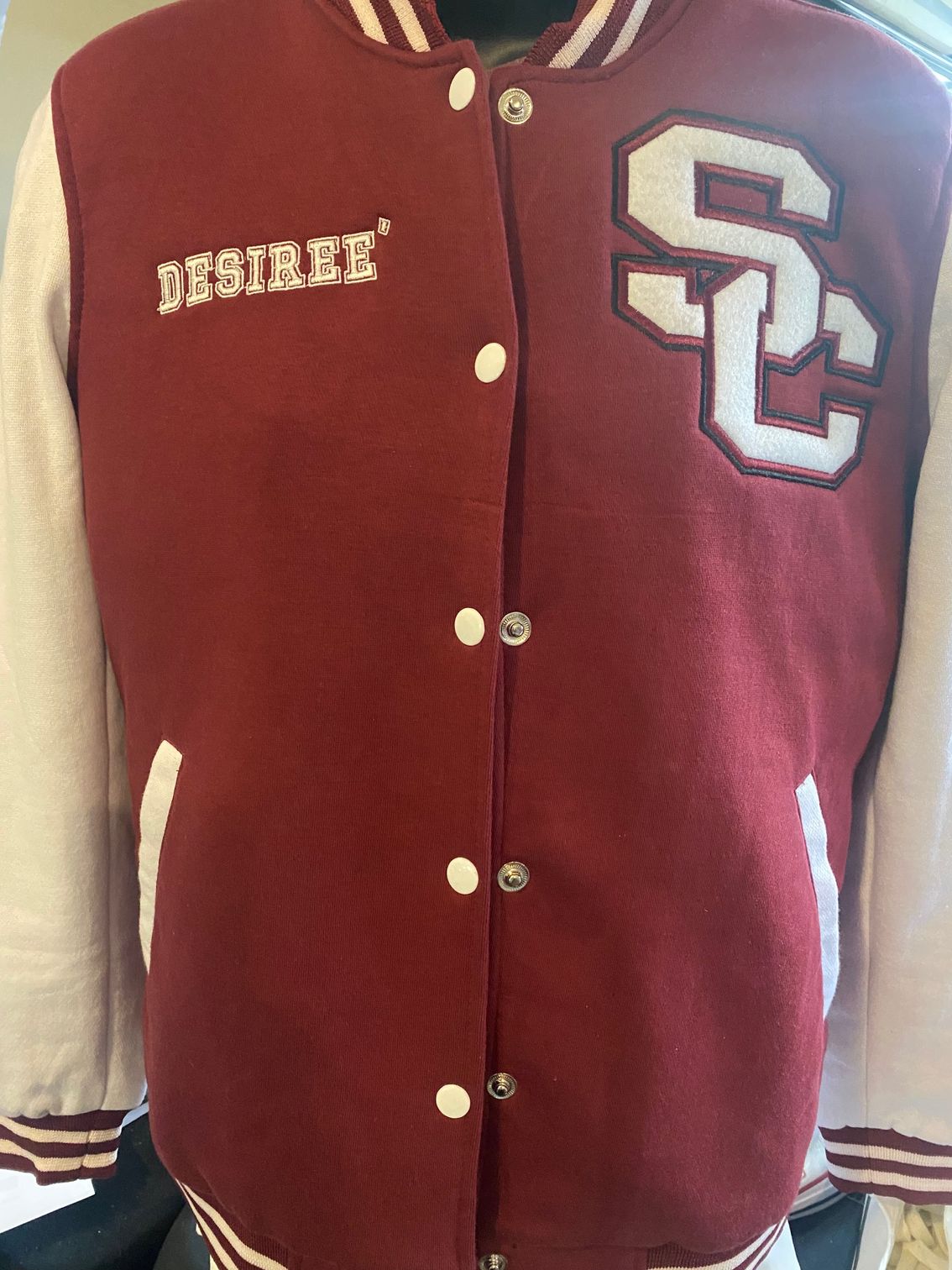 Maroon and white varsity jacket with a chenille SC letter and the name Desiree