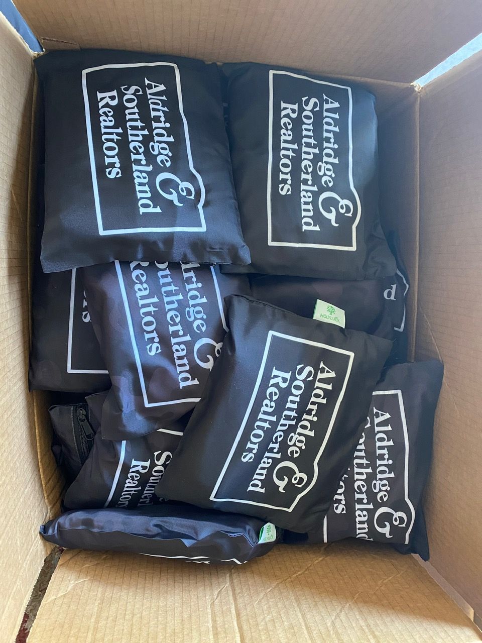 Custom branded tote bags arranged together for promotional gift planning