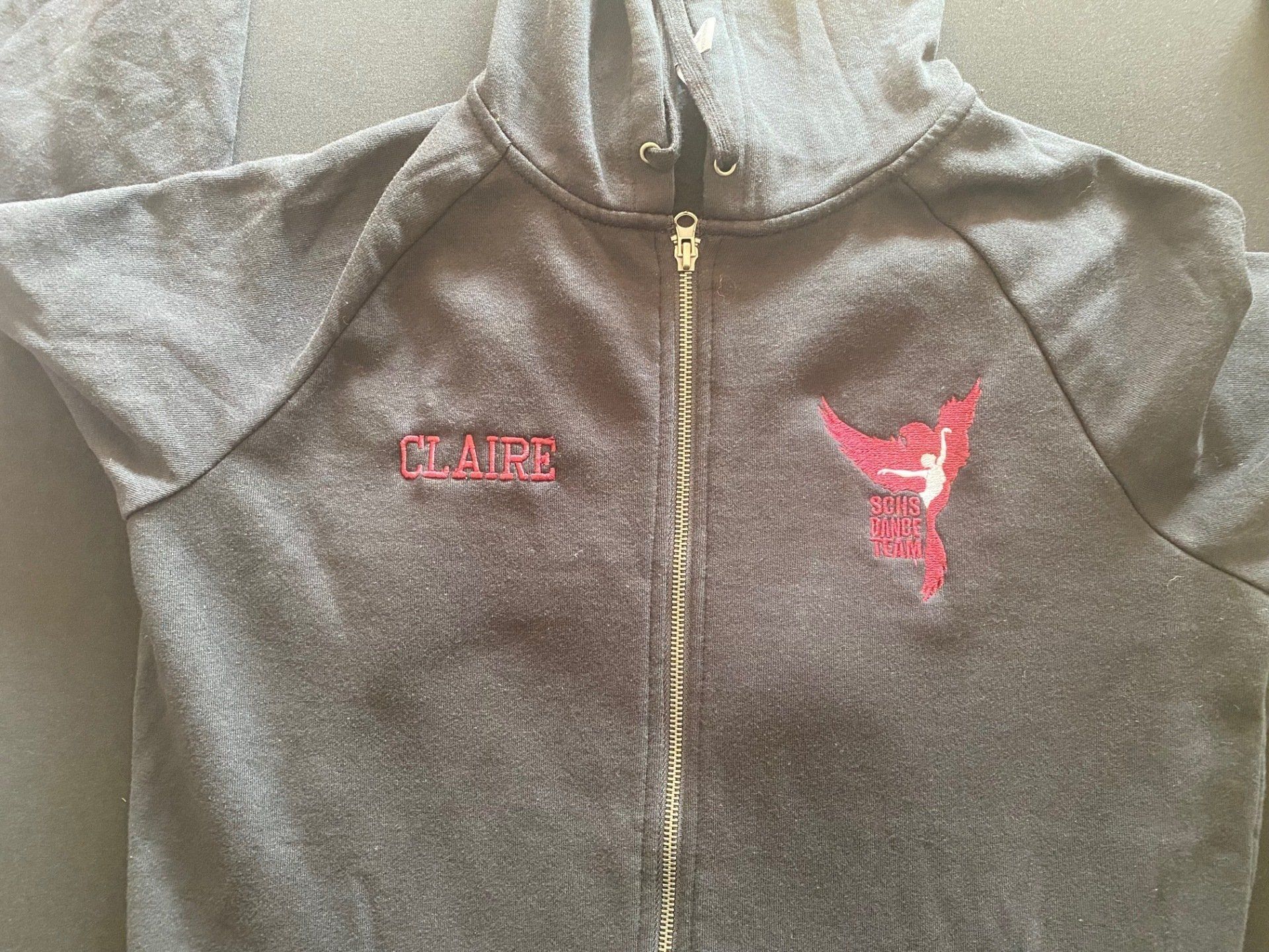 Black zip hoodie embroidered with the name Claire and an SCHS Dance Team logo